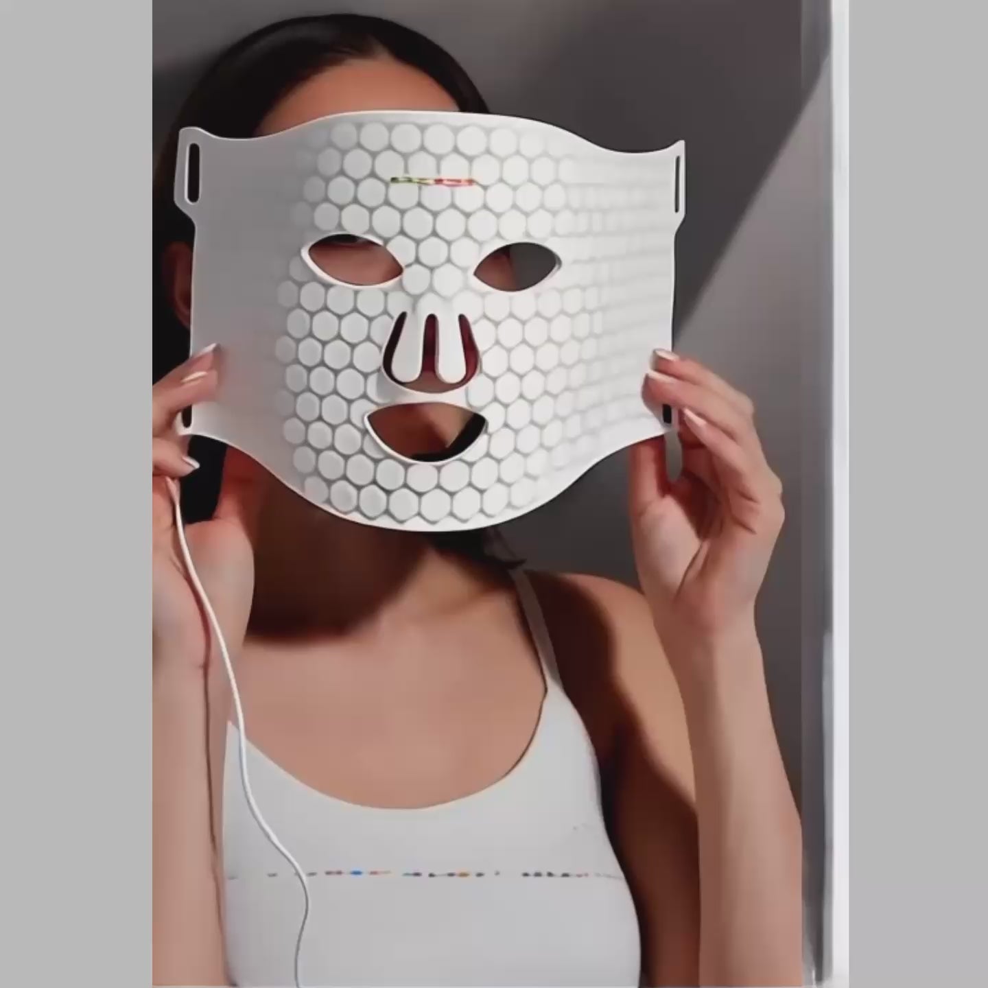 White silicone LED face mask demonstration for skin tightening and rejuvenation.