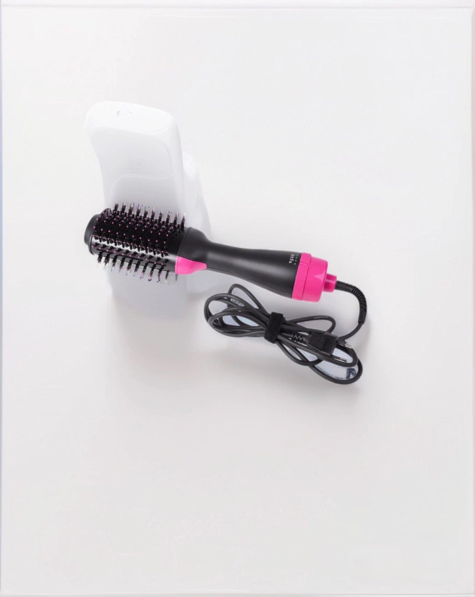 2-in-1 round hair dryer brush featuring a lightweight ceramic design for quick styling and smooth hair. 